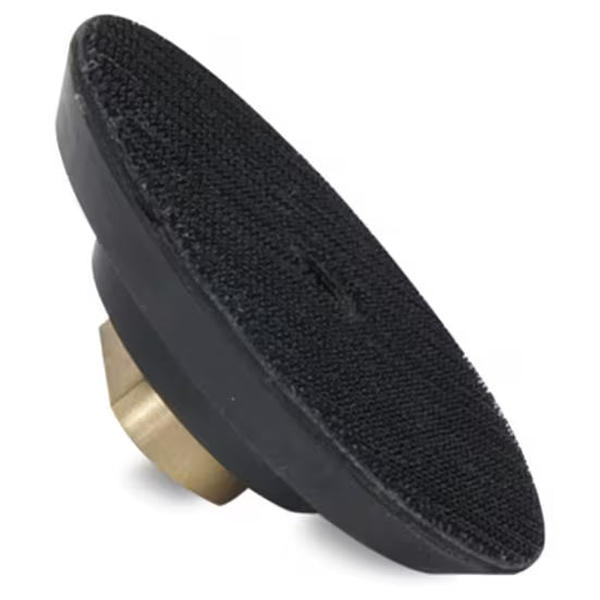 Black rubber pad with a brass center