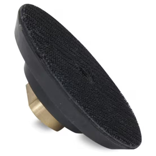 Black rubber pad with a brass center